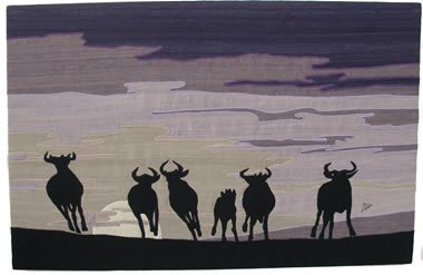 wildebeest running dusk